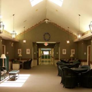 A spacious lounge area with comfortable seating and a vaulted ceiling.