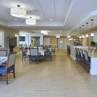 A modern dining area featuring elegant lighting and spacious seating arrangements.