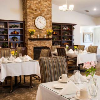 A cozy restaurant dining area with elegantly set tables and a warm, inviting decor.