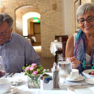 A couple enjoying a meal together at a restaurant.