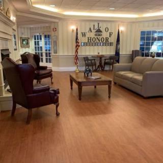 A cozy lobby area with comfortable seating and a Wall of Honor display.