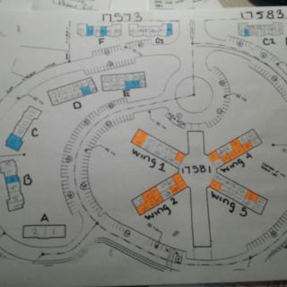 A hand-drawn floor plan layout with various sections labeled and colored in orange and blue.