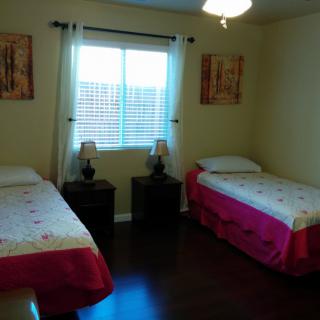 A cozy bedroom with twin beds and tasteful decor.
