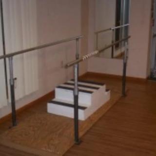 Indoor physical therapy steps with handrails for rehabilitation exercises.