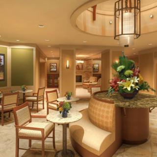 A modern lobby with elegant seating and a vibrant flower arrangement.