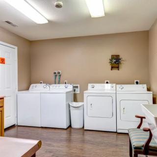 A clean and organized laundry room with two washing machines and two dryers.