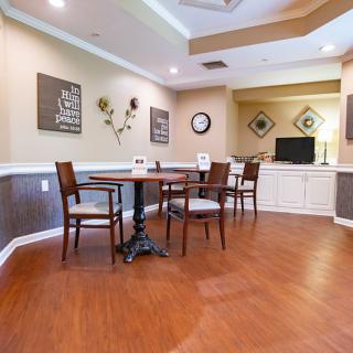 A cozy dining area with wooden flooring and elegant furniture.