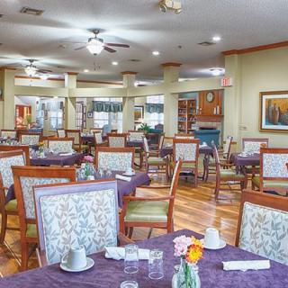 An empty dining room with neatly arranged tables and chairs.