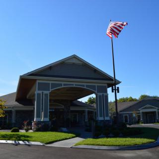 A building with an American flag flying on a clear, sunny day.
