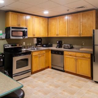 A well-equipped kitchen featuring wooden cabinets and modern appliances.