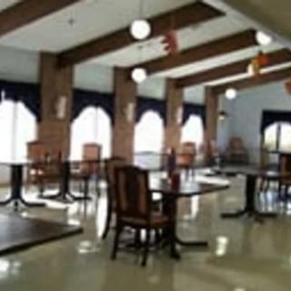 An empty restaurant interior with tables and chairs arranged neatly.
