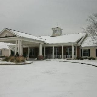 A charming residential building adorned with a fresh layer of snow during winter.
