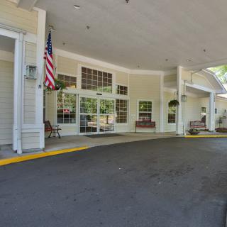 A porch entrance of a building featuring an American flag.