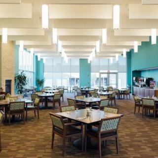 A spacious and modern dining area with tables and chairs designed for a comfortable dining experience.