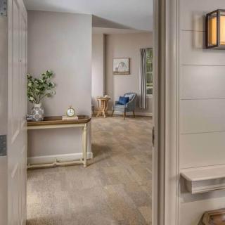 A welcoming entrance to a cozy living area with modern decor and warm lighting.
