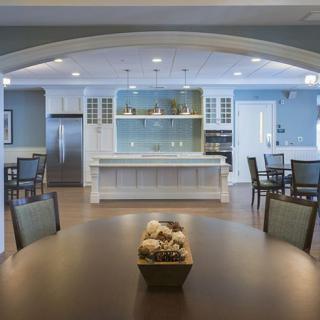 A modern open-plan kitchen and dining area featuring a spacious layout with elegant furniture and lighting.