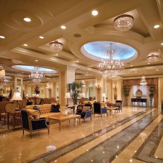 A luxurious hotel lobby featuring elegant chandeliers and comfortable seating areas.
