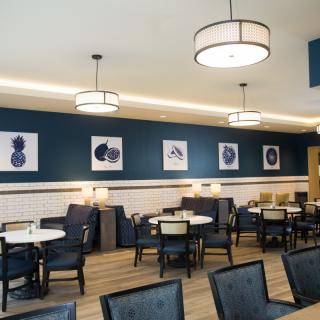 A modern restaurant interior with stylish seating and artwork on the walls.