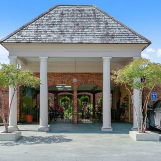 A building entrance with columns and a pitched roof.