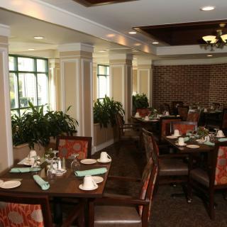 An elegant restaurant dining area with neatly arranged tables and chairs.