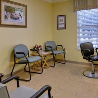 A cozy waiting room with several chairs and a small table.
