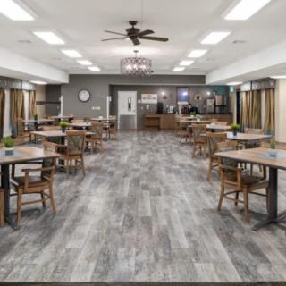 An empty dining area with modern decor and neatly arranged tables and chairs.