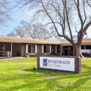 Pioneer Health facility, showcasing a welcoming exterior surrounded by greenery.