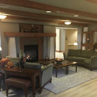 A cozy living room featuring comfortable seating and a warm fireplace.