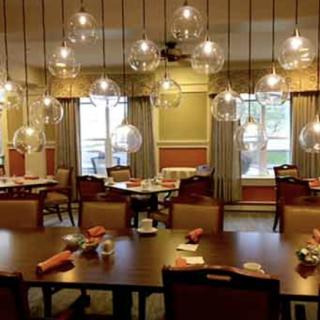 A cozy restaurant interior with elegant lighting and neatly arranged tables.