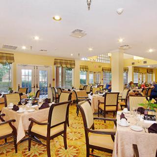An elegant dining room setting with neatly arranged tables and chairs.