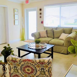 A bright and cozy living room with a comfortable sofa, decorative plants, and a stylish coffee table.