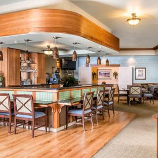 A cozy bar and dining area with wooden furniture and soft lighting.