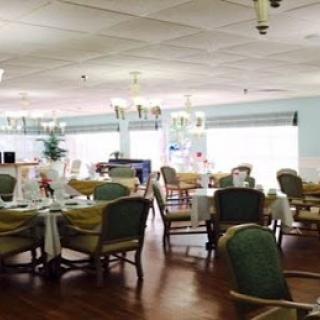 A spacious and elegantly designed dining area showcasing comfortable seating and a warm atmosphere.