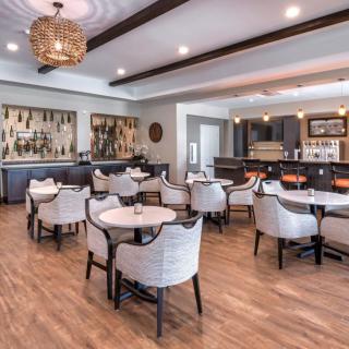 A modern restaurant interior with a cozy dining area and bar.