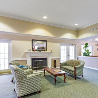 A cozy living room featuring elegant furniture and a fireplace.
