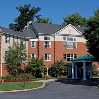 A residential building with landscaped grounds and a covered entrance.