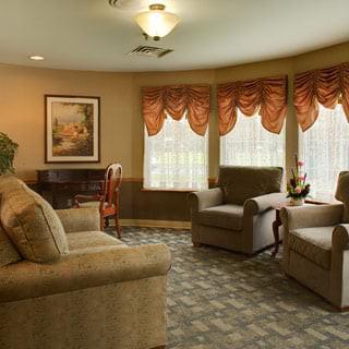 A cozy living room with comfortable seating and large windows.