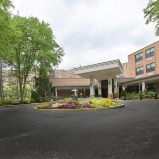 A well-landscaped hotel entrance with a circular driveway.