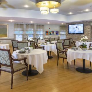 A cozy dining room with elegantly set tables and comfortable seating.