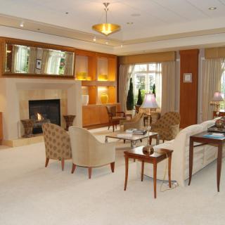 A luxurious and cozy living room with a fireplace, elegant furniture, and sophisticated decor.