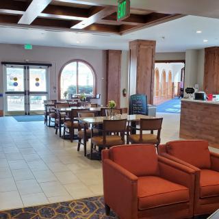 A spacious lobby with seating area and reception desk.