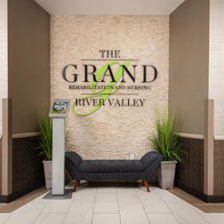 The welcoming lobby of The Grand at River Valley, featuring contemporary design and cozy seating.