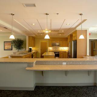 A spacious and modern kitchen interior featuring a countertop, appliances, and warm lighting.