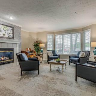 A modern living room with a cozy seating arrangement and a fireplace.