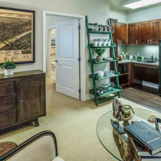 A cozy apartment interior featuring a kitchen and living area with modern decor.