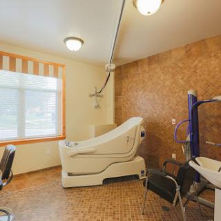 A well-equipped treatment room in a modern clinic, featuring a medical examination chair and comfortable seating.