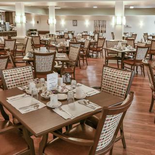 Empty restaurant dining area with neatly arranged tables and chairs.
