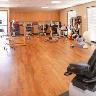 A well-equipped gym with various exercise machines and a spacious workout area.