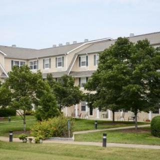 A suburban apartment complex with well-maintained landscaping.