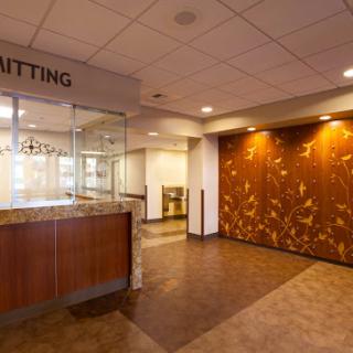 A spacious and modern waiting area with a reception desk, designed for comfort and accessibility.